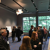 People reading posters during business analytics event