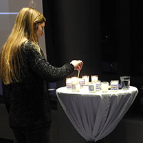 Student lighting candle at Kristallnacht commemoration