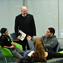 Students with Br. Jack Curran in Kelly Commons