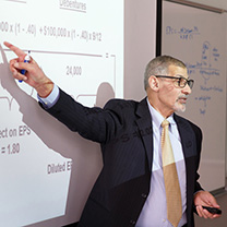Professor Ahmed Goma pointing at board