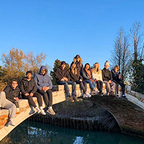 Students sitting on bridge overseas