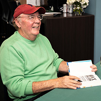 James Patterson signing a book on campus