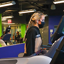 Student on treadmill in fitness center