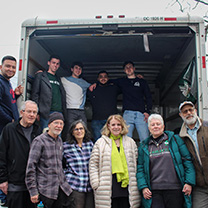 Students, faculty and staff outside moving van