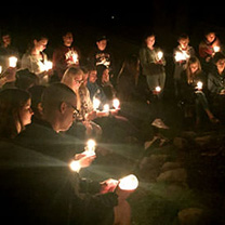 Students on Kairos retreat holding candles