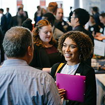 Student talking to employer at career fair