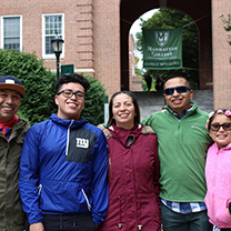 Family in front of archway banner