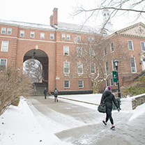 Student walking in snow on campus